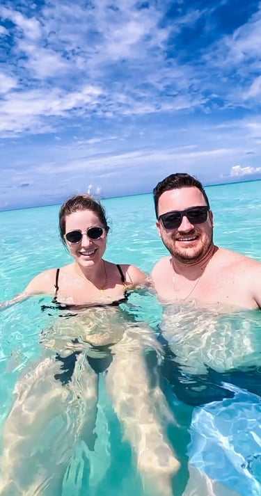 a man and woman in bikinis in the ocean