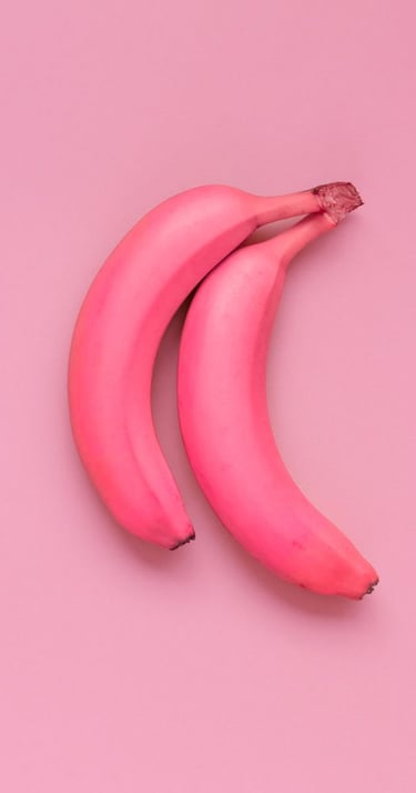 two bananas are shown on a pink background