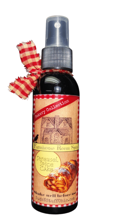 a bottle of "spice cake" room spray with a red rustic ribbon tied to it