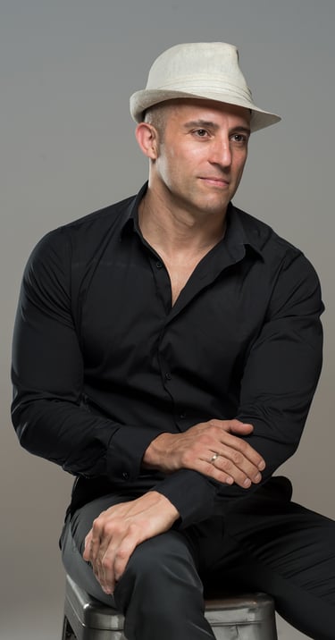 a man in a hat and a hat on a chair