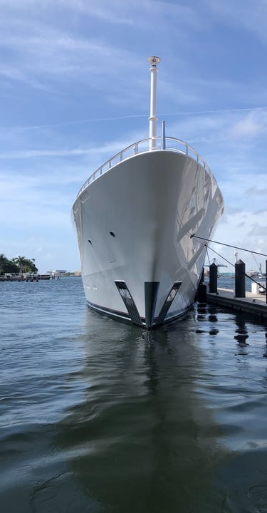 a large white yacht docked at our dock