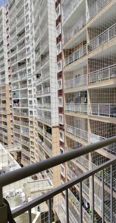 a balcony with a view of a pool and a fenced in area