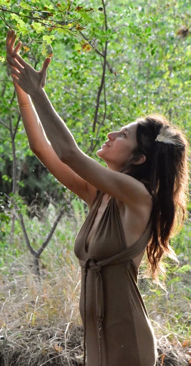a woman in a brown dress is reaching for a fruit