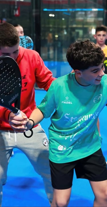Padel coach demonstrating shot technique during group training session near Barcelona