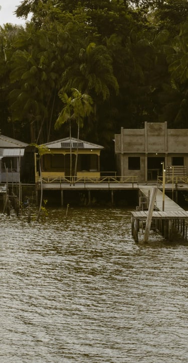 a boat dock with a house on the water