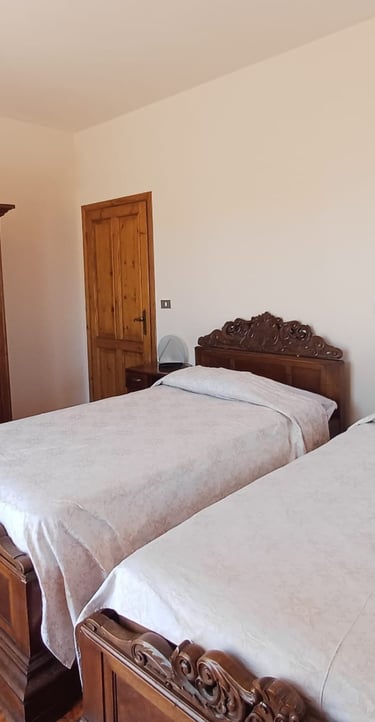 Camera doppia B&B Saludecio con due letti king size e arredi classici.