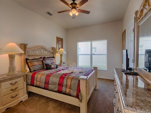 a Master bedroom with a bed and a television