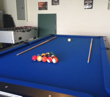 a pool table with a pool ball and a foosball table