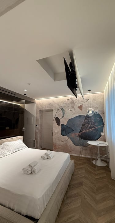 a bedroom with a bed and a television