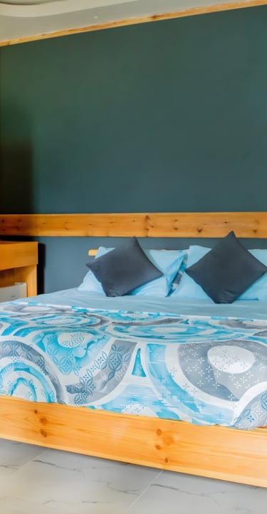 a bed with a blue bedding and a wooden bed