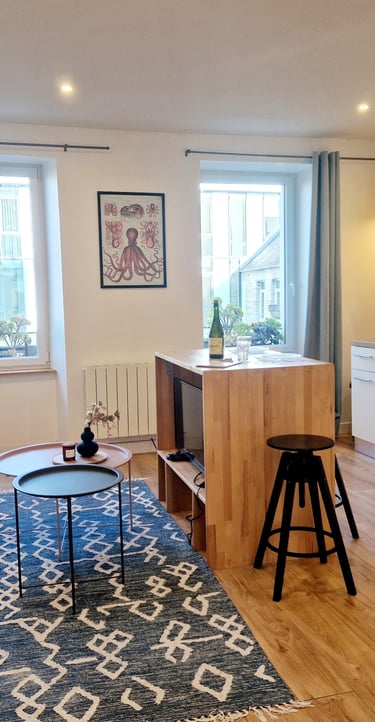 a living room with a couch and a kitchen