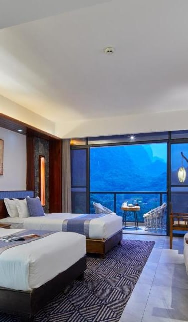 Spacious twin room at Li River Resort in Yangshuo with a balcony