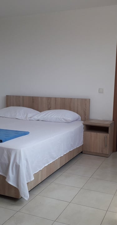 a bed with a blue blanket and a blue blanket