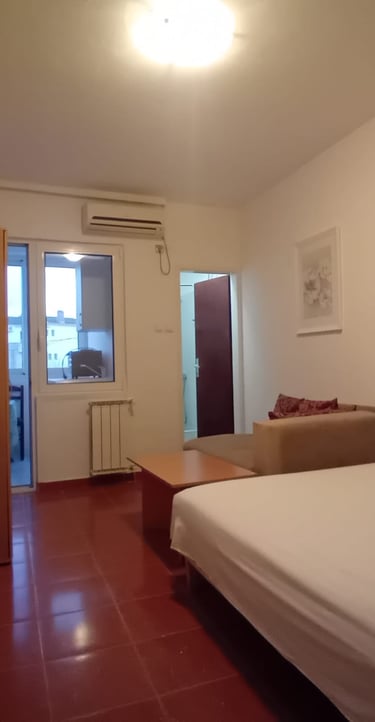 a bedroom with a bed and a television