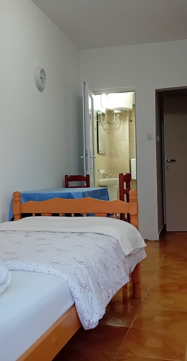 a bed with a television and a refrigerator