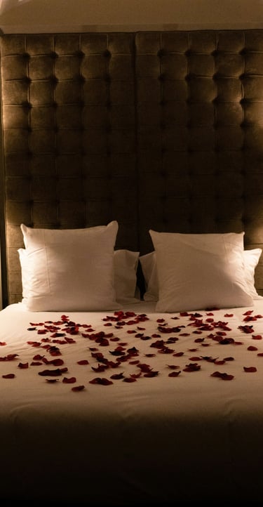 ein Bett mit Rosenblättern darauf