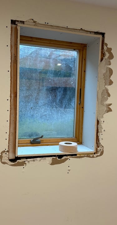 damaged drywall around window in residential home