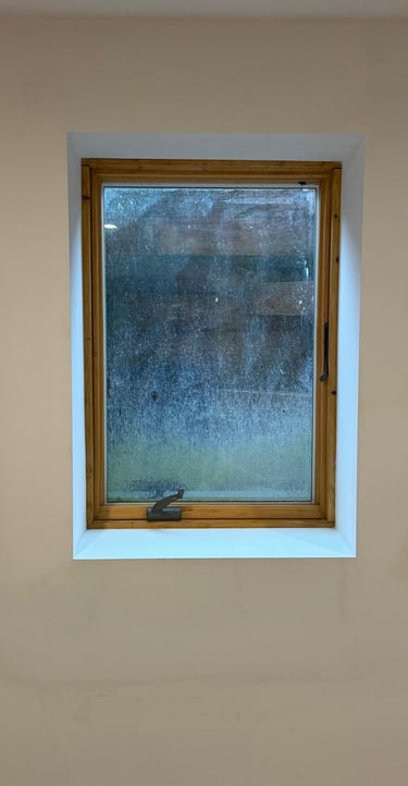 repaired drywall around window in residential basement