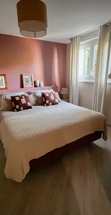 a bedroom with a bed and a wooden cabinet