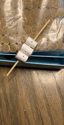 wooden skewer with moxa rolls threaded on it. this is needle moxa - aka "kyutoshin" in japanese