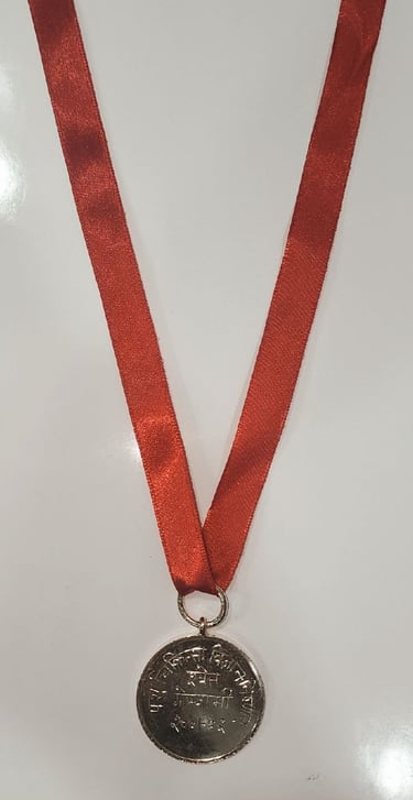 Gold medal with a red ribbon symbolizing achievement and excellence.