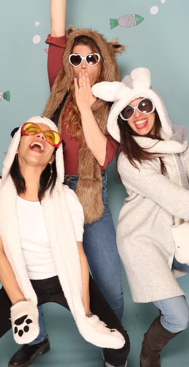 three women in animal print clothing posing for a photo