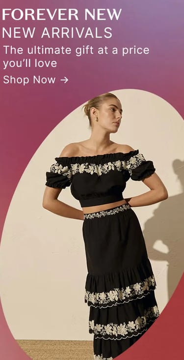 Woman wearing a Forever New black off-the-shoulder crop top and matching tiered floral embroidered skirt.