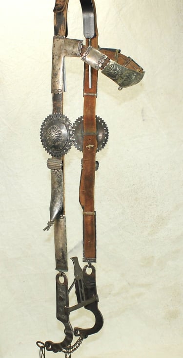 Vintage Western bridle with intricate leather tooling and silver conchos, perfect for collectors.