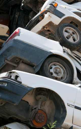 Junk cars stacked three high.