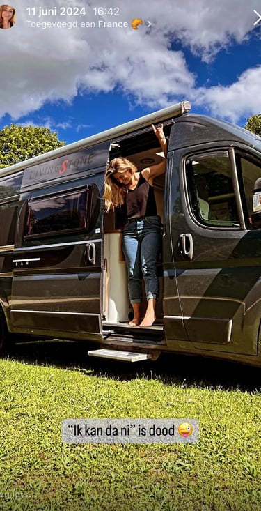 Smiling woman in a camper van — symbolizing taking life back into her own hands