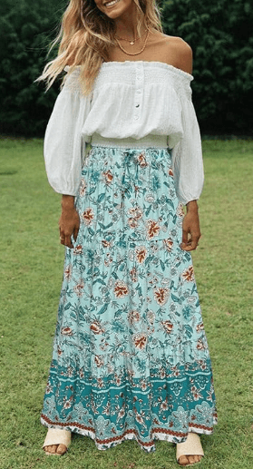a woman in a white top and blue skirt