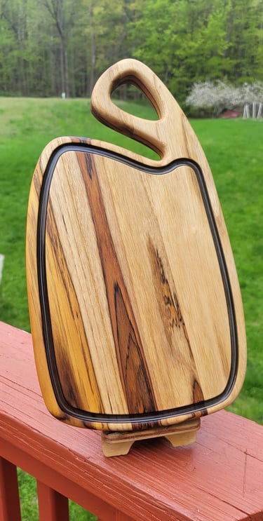 handcrafted wooden cutting boards in different sizes and wood types, showing quality craftsmanship.