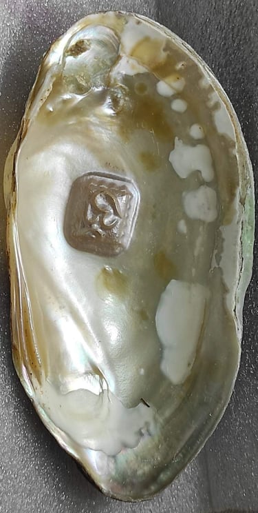 "Side view of 11mm white designer cultured pearl with detailed Om engraving–Globally tradable"