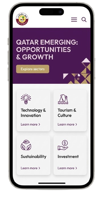 A mobile phone displaying the Qatar Emerging website featuring investment, tourism, and technology growth sectors.
