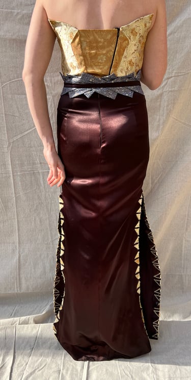The full back of a gold brocade and brown satin evening gown