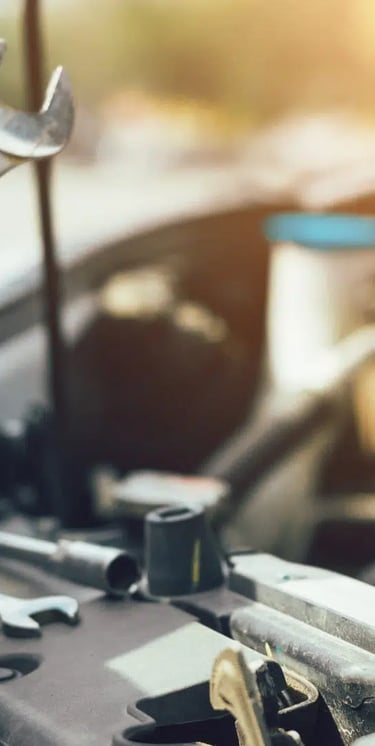 a man working on a car with a wrench