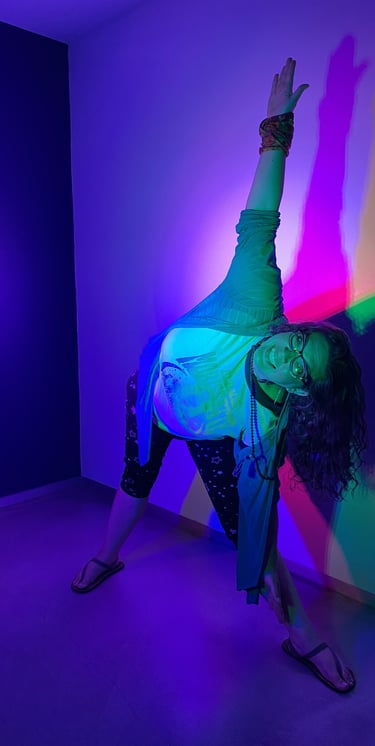 Rachel in yoga pose with neon colorful lights