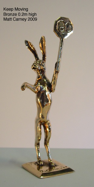 a statue of a rabbit with a stop/go sign