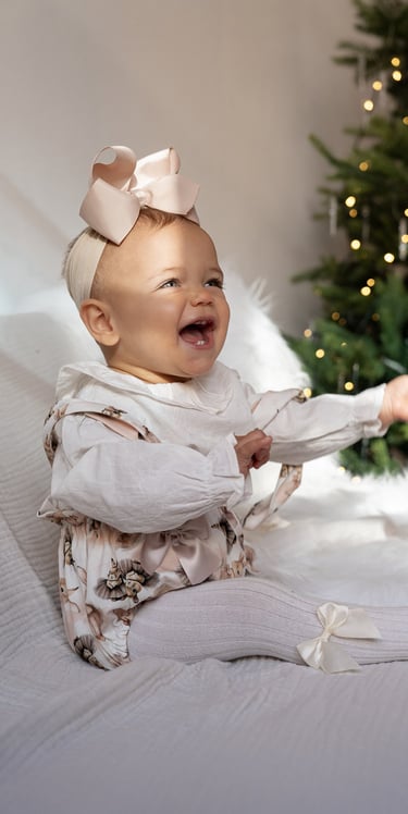 Smiling baby portrait captured during a Christmas family photography session.