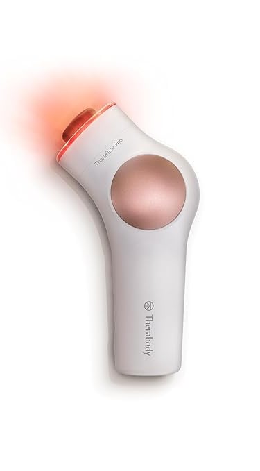 a white and pink hair dryer with a red light on it