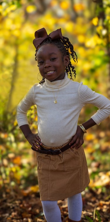 A young girl pictured in a fall setting