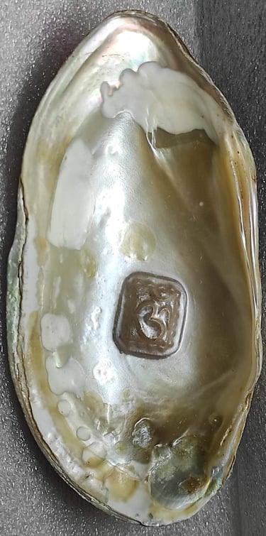 "Approx 11mm white cultured pearl featuring engraved Om symbol–using nucleus implantation-Prepared for export"