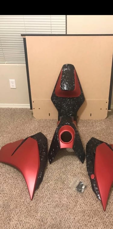 motorcycle bodywork wrapped in red and forged carbon wrap. for a ktm 390