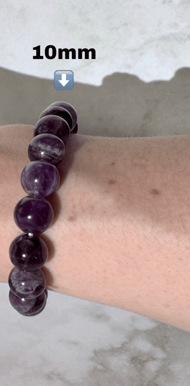 The first half a photo of a wrist with 2 amethyst crystal bracelets on it,this side is the 10mm size