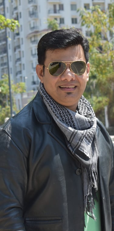 a man in a black jacket and sunglasses, raheel ahmed