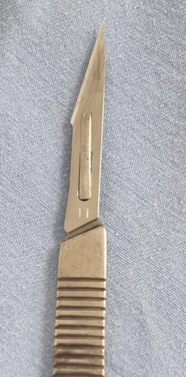 a knife and a knife blade on a blue cloth