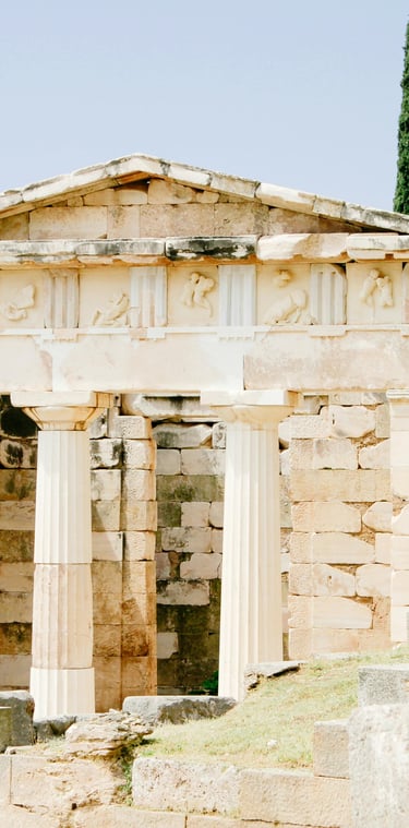 a small stone building with columns and columns