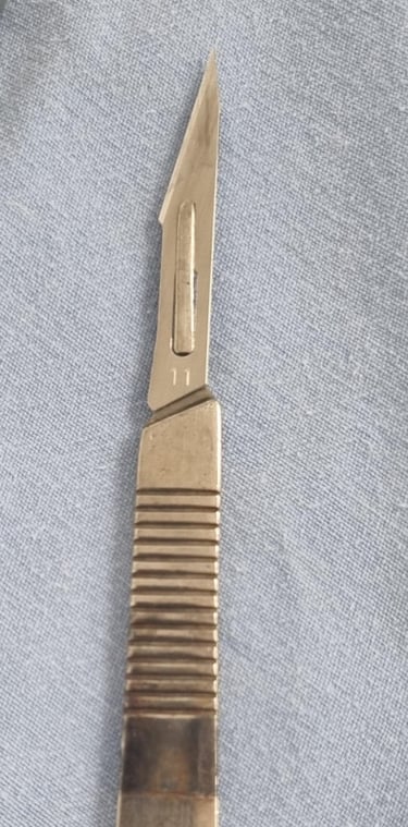 a knife and a knife blade on a blue cloth