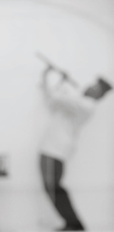 a man in a white shirt is playing the recorder