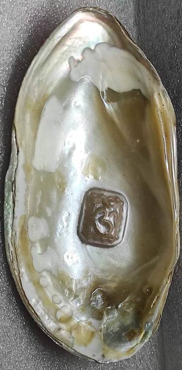 "Approx 11mm white cultured pearl featuring engraved Om symbol–using nucleus implantation-Prepared for export"